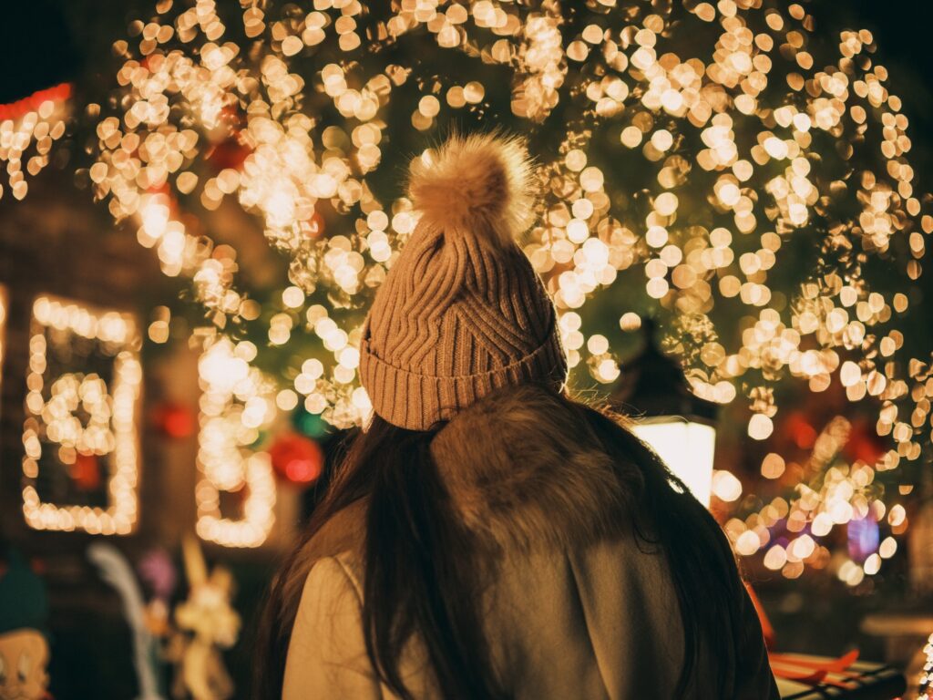 A woman enjoying Christmas lights during the holiday season