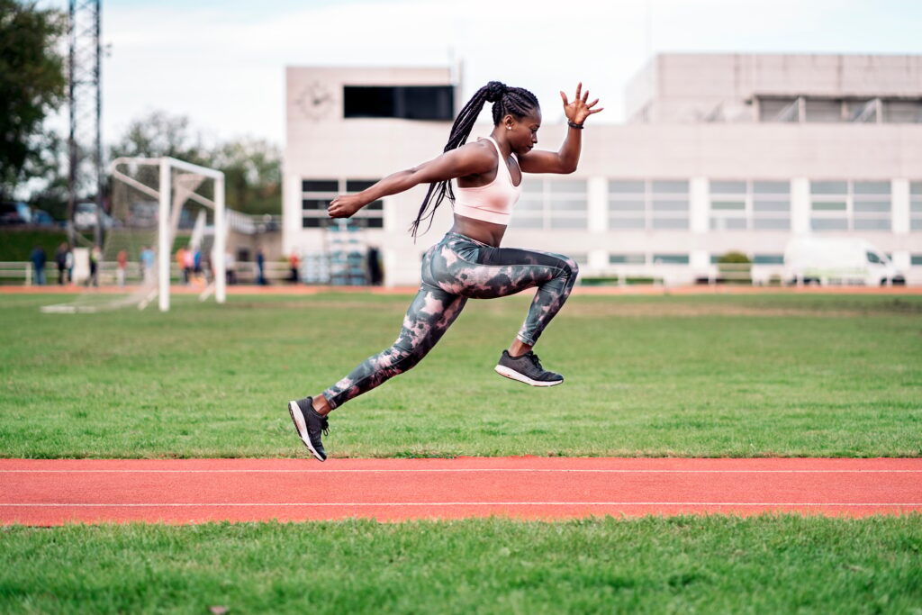 African-American athlete sprinter jumping. Sport