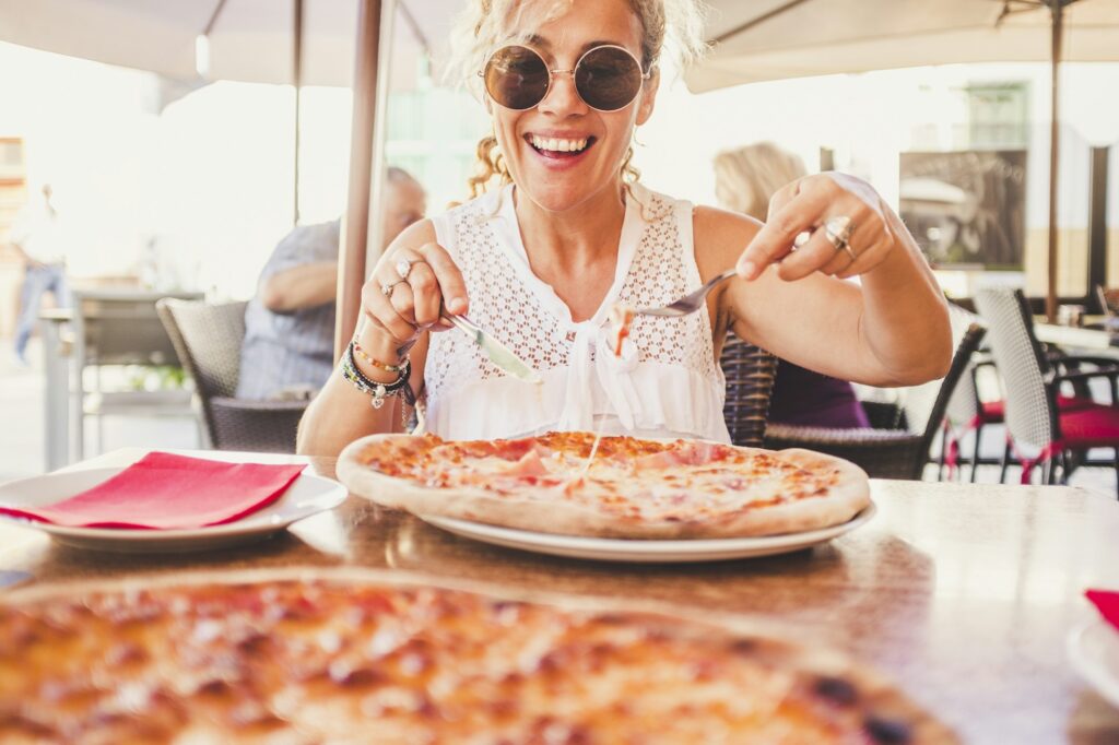 Happy beautiful caucasian lady and pizza