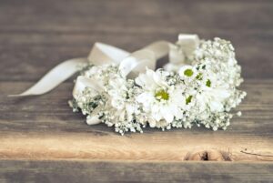 Wreath of chamomile flowers on the wooden floor