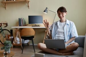 Young woman waving for video chat